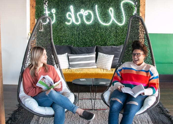 Two girls reading in chairs