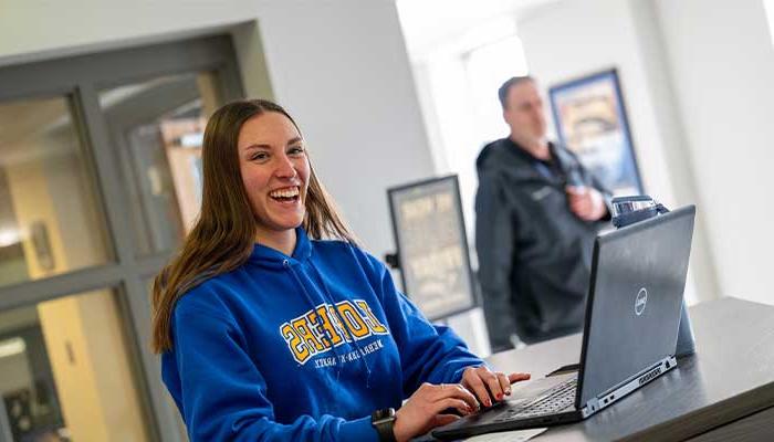 Cassidy at the welcome desk greeting